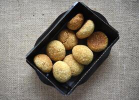 Sweet sesame cookies in cardboard boxes on burlap. Cookies in a box. photo