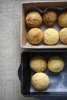 Sweet sesame cookies in cardboard boxes on burlap. Cookies in a box. photo