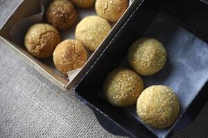 Sweet sesame cookies in cardboard boxes on burlap. Cookies in a box. photo