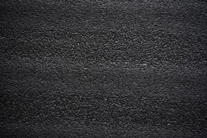 Black porous porous foam background. Background texture of black foam rubber photo