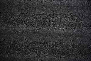 Black porous porous foam background. Background texture of black foam rubber photo