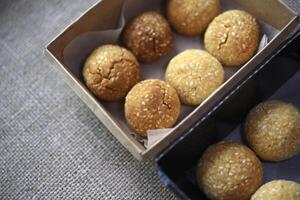 Sweet sesame cookies in cardboard boxes on burlap. Cookies in a box. photo