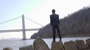 Lifestyle Portrait of Man in Suit Enjoying River Bridge Landscape Outdoors video