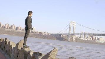 Lifestyle Portrait of Man in Suit Enjoying River Bridge Landscape Outdoors video