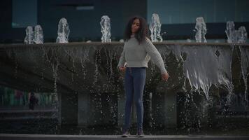 Happy Young Woman with Curly Hair Dancing on City Street in Slow Motion video