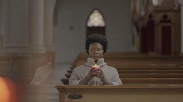 Young African Woman With Curly Hair Praying Inside Church video