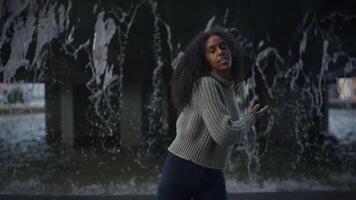 Happy Young Woman with Curly Hair Dancing on City Street in Slow Motion video