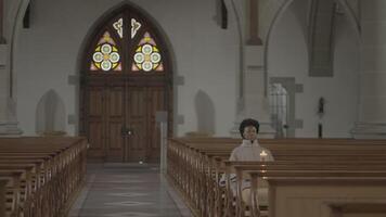 Young African Woman With Curly Hair Praying Inside Church video