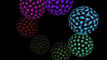 Colorful polka dot balls float on black background video