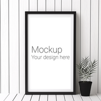 Mockup of black frame for poster or photo on white striped wall background with potted flower psd