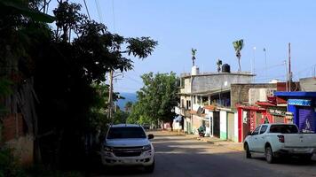 Puerto Escondido Oaxaca Mexico 2022 Colorful street with houses palms cars jungle Puerto Escondido Mexico. video