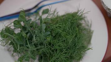 chopped dill in a white plate on the table, salad greens video