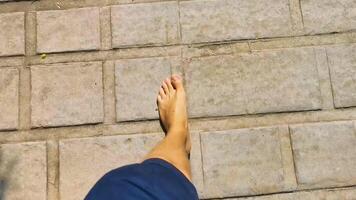 Walking on the pavement rocks stones feet barefoot in Mexico. video