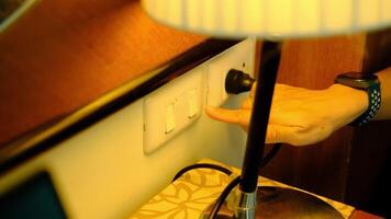 A woman's hand is pulling an electrical plug to turn off a switch. to save energy video