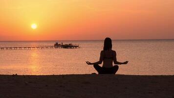 Beautiful Woman meditate on Marine Beach. One Adult Girl at Bright Scenic Sea. Modern Romance of Ocean Bathing and Amazing Summer Sky at Sundown. video