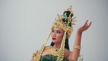 Woman in traditional Balinese dance costume performing with elegant hand gesture. video