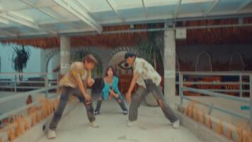 Three young adults dancing in a retro-styled room with vintage decor. video