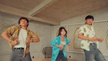 Blurred image of three young people dancing joyfully with a carefree attitude in a casual setting. video