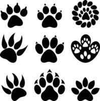 set of black silhouettes of different animal paw vector