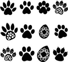 set of black silhouettes of different animal paw vector