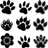 set of black silhouettes of different animal paw vector