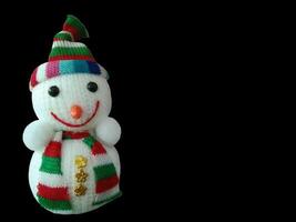 Christmas smile yarn snowman isolated on black background with copy space. photo