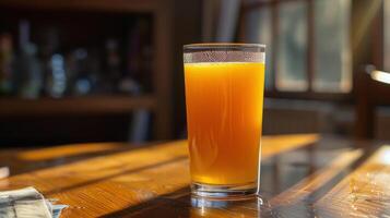 Glass of Orange Juice on Wooden Table photo