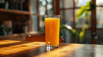 Glass of Orange Juice on Wooden Table photo