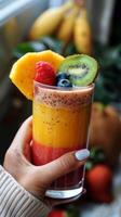 Person Holding Cup Filled With Fruit photo