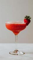 Glass of Strawberry Martini With Fresh Strawberries photo