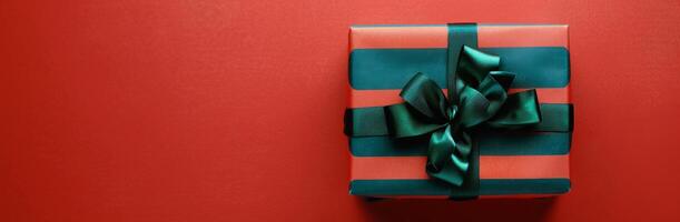 Green and Red Wrapped Present on Red Background photo