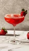 Glass of Strawberry Martini With Fresh Strawberries photo