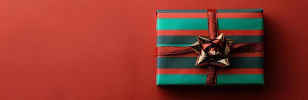 Green and Red Wrapped Present on Red Background photo