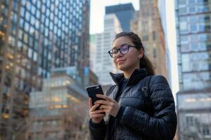 Woman Wearing Glasses Looking at Cell Phone photo