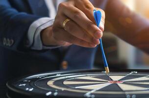 Man in Suit Aiming Dart at Dart With Pen photo