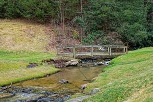 Wooden bridge over a creek photo