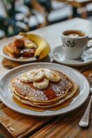 Stack of Pancakes With Bananas and Syrup photo
