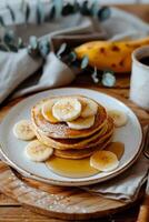Stack of Pancakes With Bananas and Syrup photo