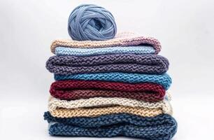 Pile of Knitted Blankets and Balls of Yarn photo