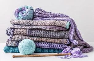 Pile of Knitted Blankets and Yarn Balls photo