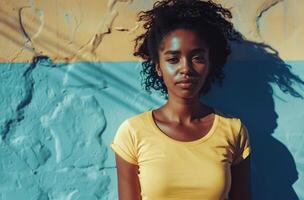 Woman Standing in Front of Blue and Yellow Wall photo