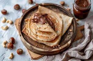 Plate of Pancakes With Nuts and Chocolate Sauce photo