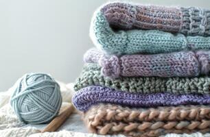 Pile of Knitted Blankets and Yarn Balls photo