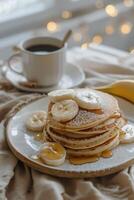 Stack of Pancakes With Bananas and Syrup photo