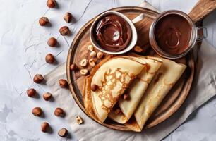 Plate of Pancakes With Nuts and Chocolate Sauce photo