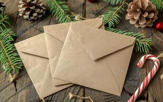 Three Envelopes With Candy Canes on a Wooden Table photo