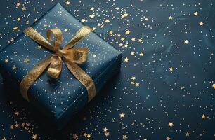 Gift Box With Gold Ribbon on Blue Background photo