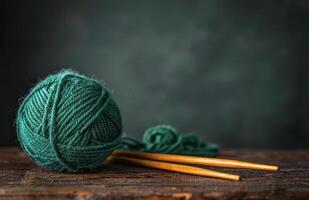 Green Yarn Ball and Knitting Needle on Wooden Table photo