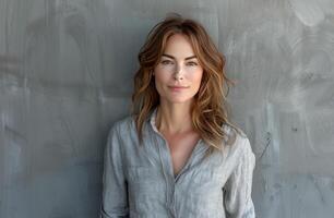 Woman in Gray Shirt Leaning Against Wall photo