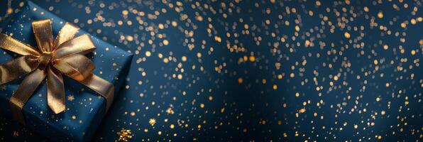 Gift Box With Gold Ribbon on Blue Background photo